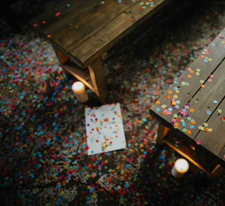 Multicoloured confetti settled on trestle table and bench