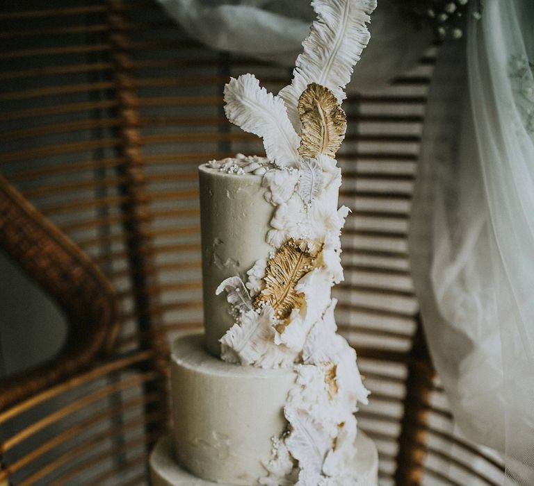 Wedding cake with feather design trailing down the front 