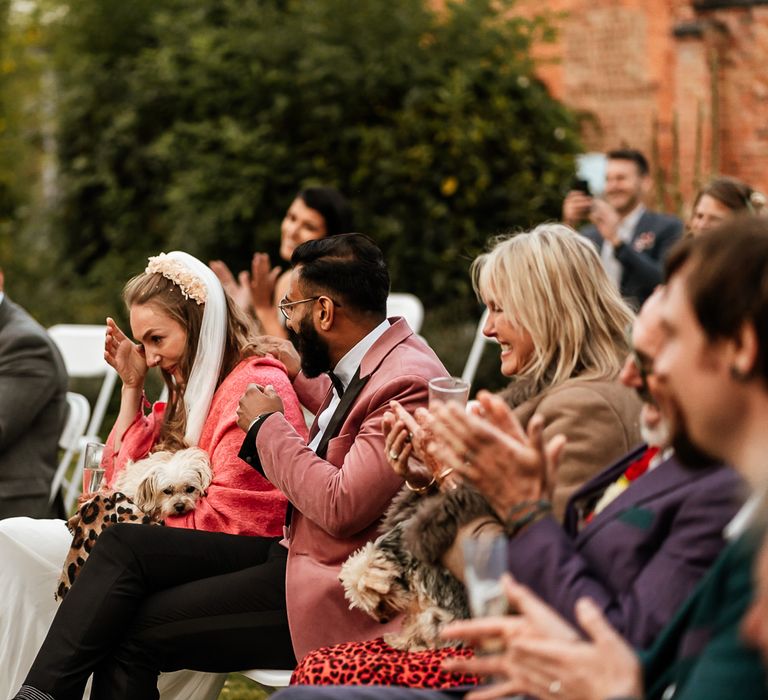 Wedding party sit outside and bride becomes emotional during speeches 