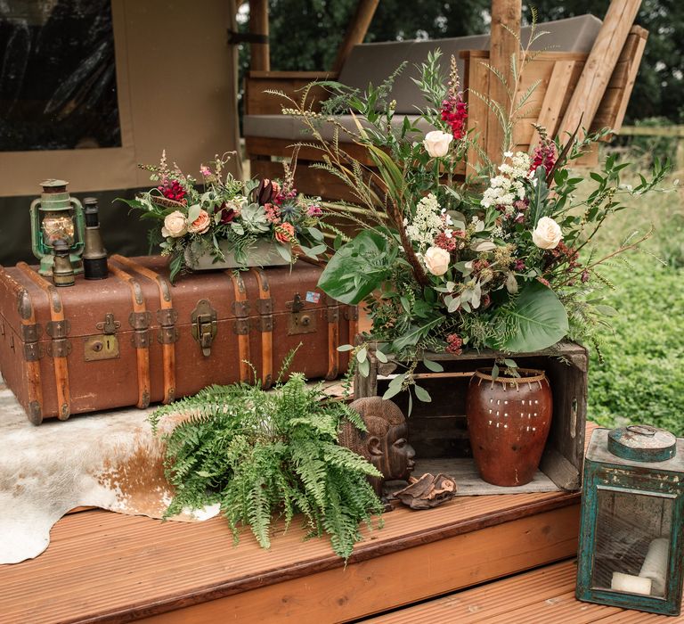 Safari inspired floral decor featuring brown suitcase 