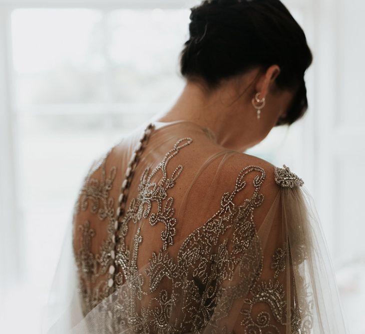 The back of a homemade wedding dress with embellishment details.