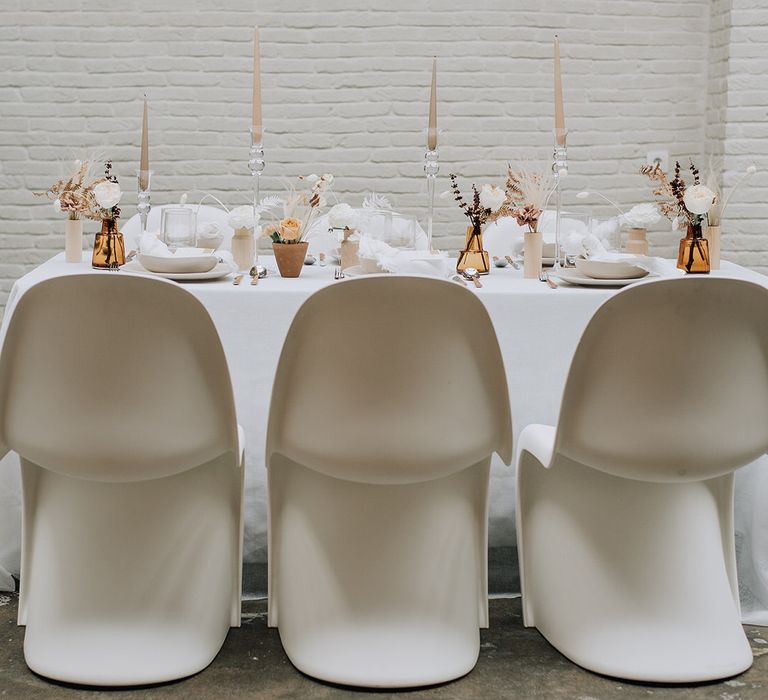 Modern curved white seating with an all white tablescape