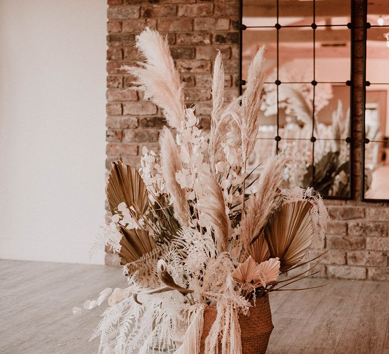 Dried flower arrangement in a basket for wedding ceremony decor