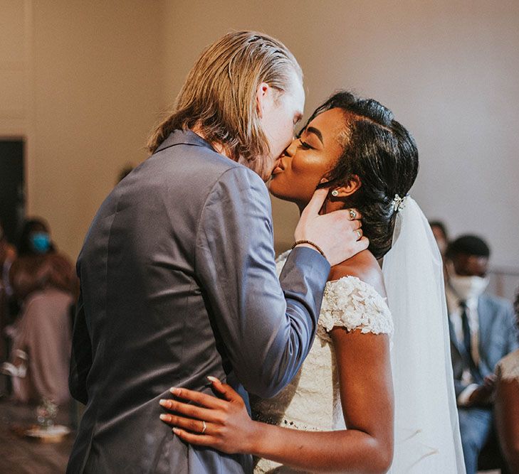 Intimate Heart Church wedding ceremony in Nottingham with the groom kissing his bride