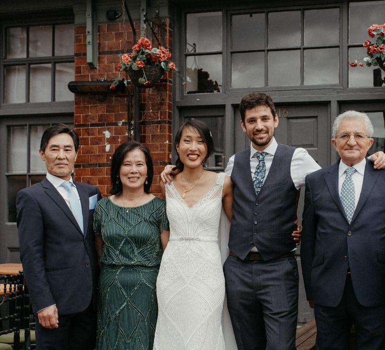 The bride and groom with each of their parents beside them