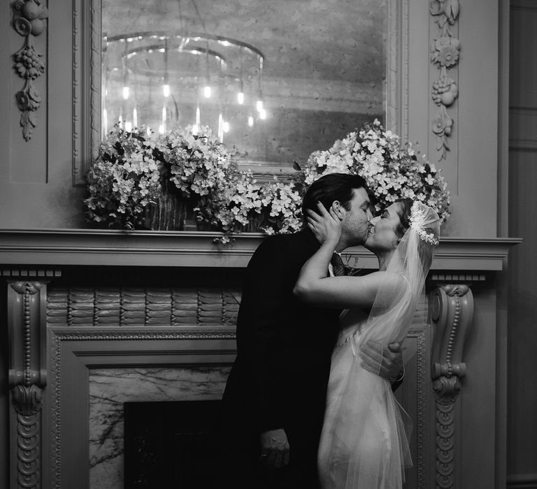 Groom kissing his bride at an intimate town hall wedding ceremony at Old Marylebone Town Hall 