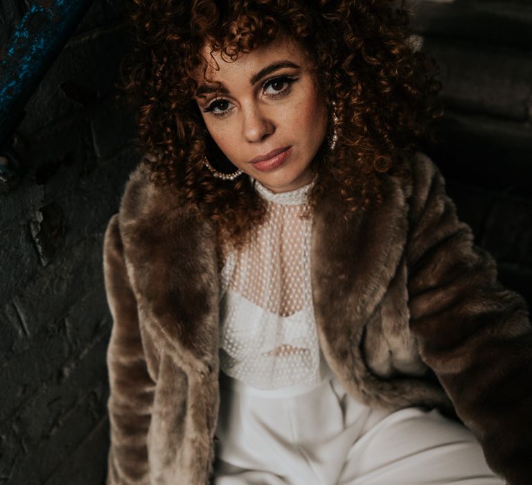 Beautiful bride with naturally curly hair in a brown faux fur coat and hoop earrings by Victoria Louise Accessories 