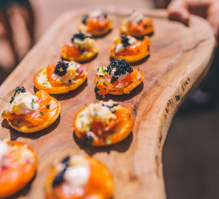 Canapés on wooden board for outdoor wedding   | Story + Colour