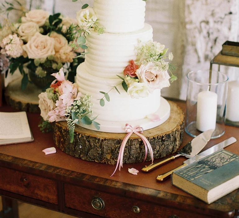 Wedding cake complete with 3-tiers, floral decoration and white frosting