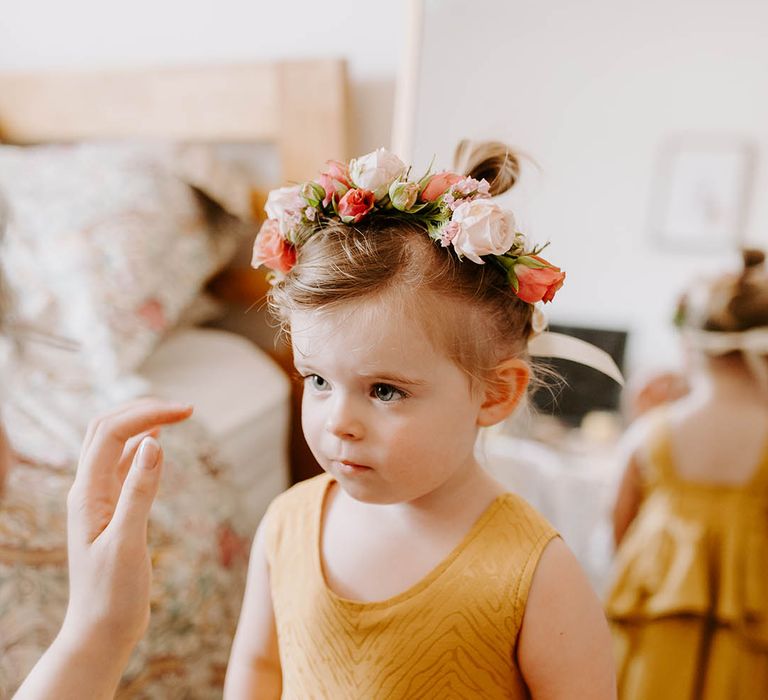 Flower girls wears floral crown and yellow custom made bridesmaid dress