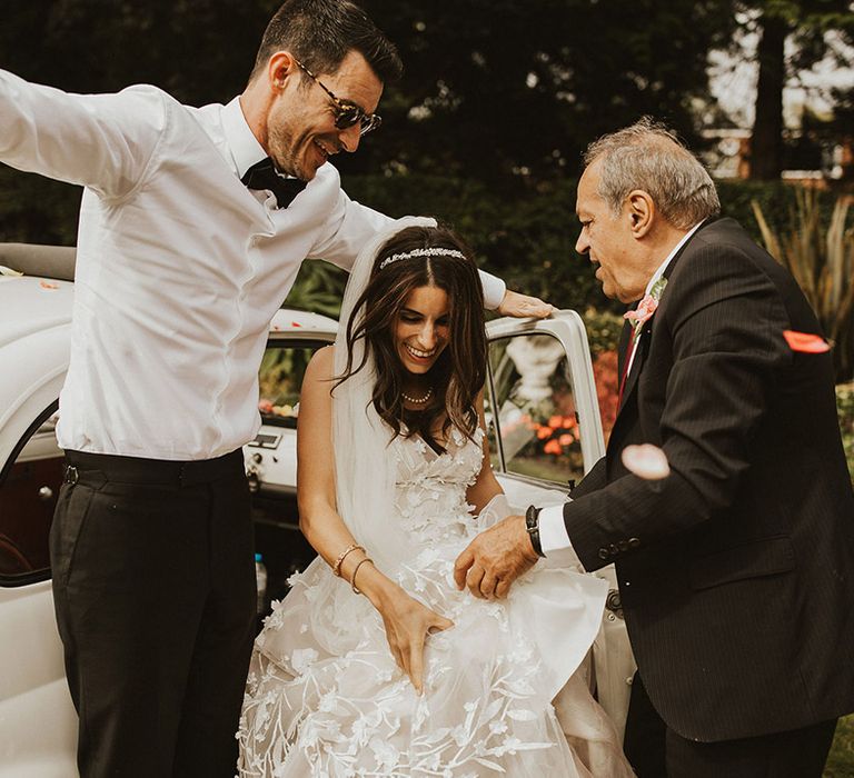 Bride is helped out of Fiat 500