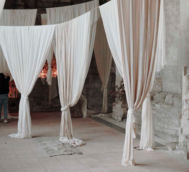 Hanging fabric installations in neutral tones at modern Blackfriars Priory wedding 