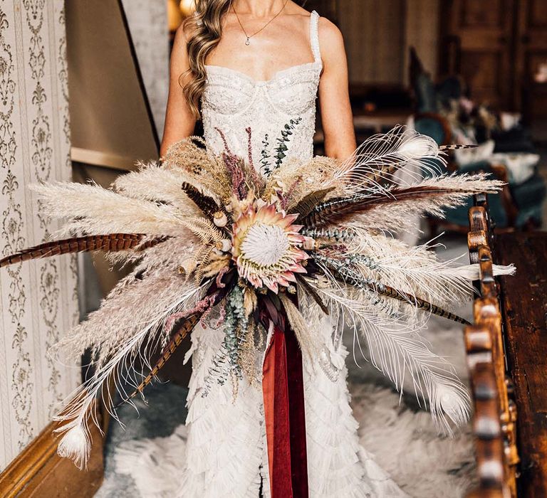 Bride holds pampas grass bouquet 