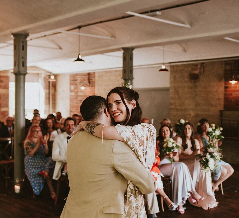 Bride & groom hug during wedding ceremony