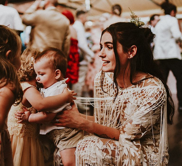 Bride with her baby on the day of her wedding