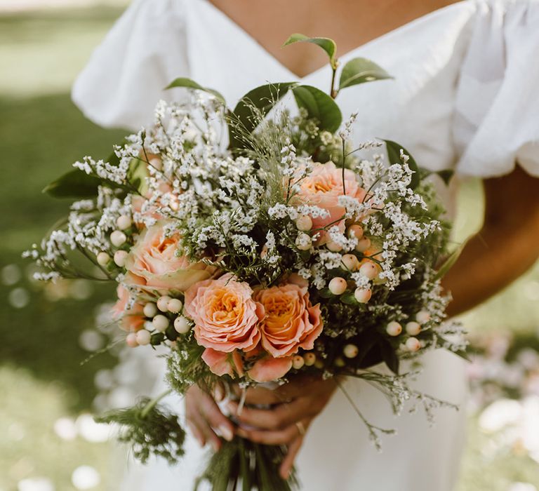  Bride holding pink and white bouquet 