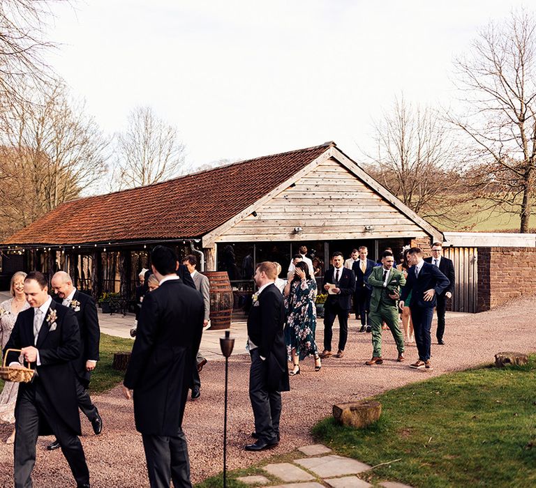 Wedding guests exit the wedding ceremony on the way to the reception 