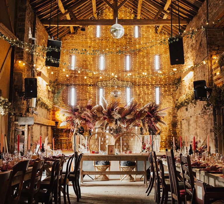 Retro style wedding with colourful candles with fairy lights, pampas grass flower cloud 