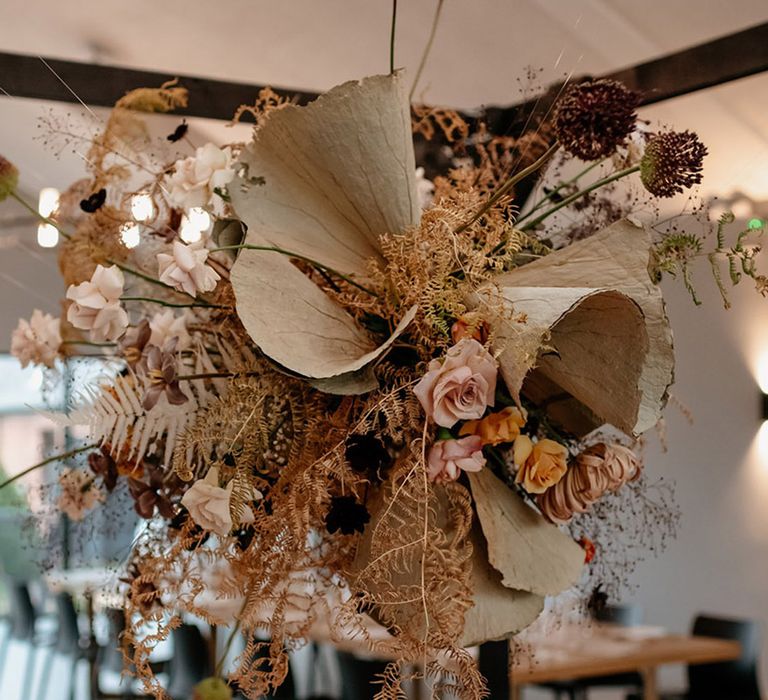 Epic dried flower cloud for neutral autumnal wedding hanging over the top table with a custom black cabana 