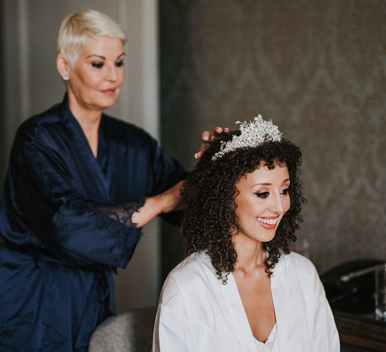 Black bride wears pearl embellished bridal crown in her naturally curly hair on the morning of her wedding day