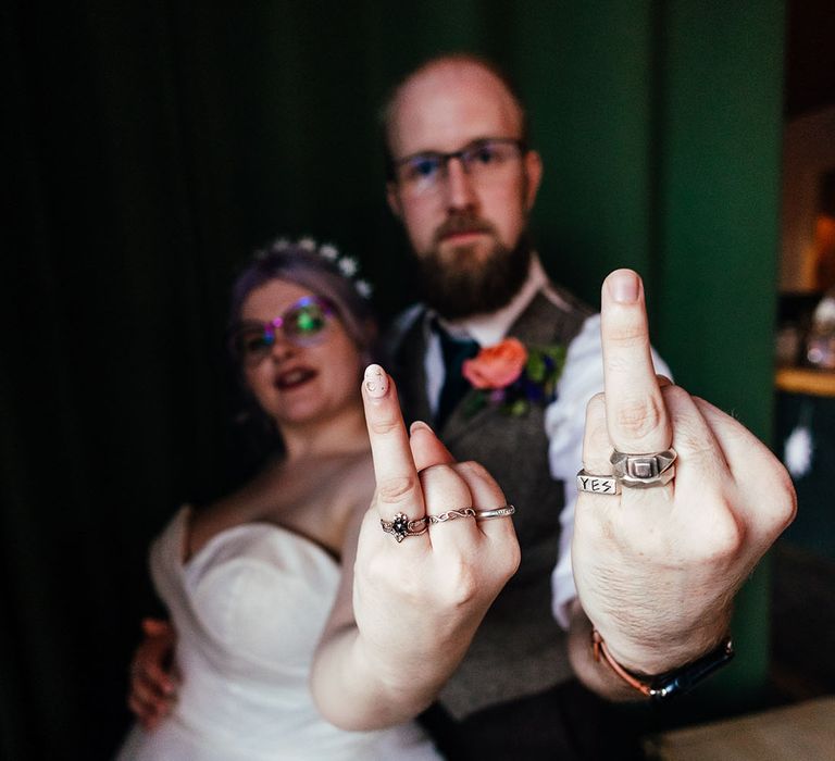 Bride and groom showing off their wedding rings at The Asylum Chapel London wedding venue 