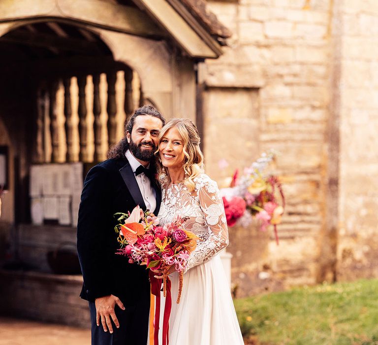 Bride in a Margaux Tardits delicate lace wedding dress with groom in black tie 