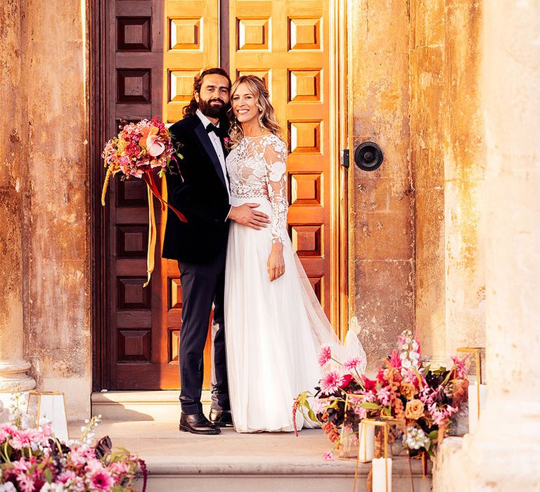 Groom in black tie wedding suit with the bride at Elmore Court in Gloucestershire 