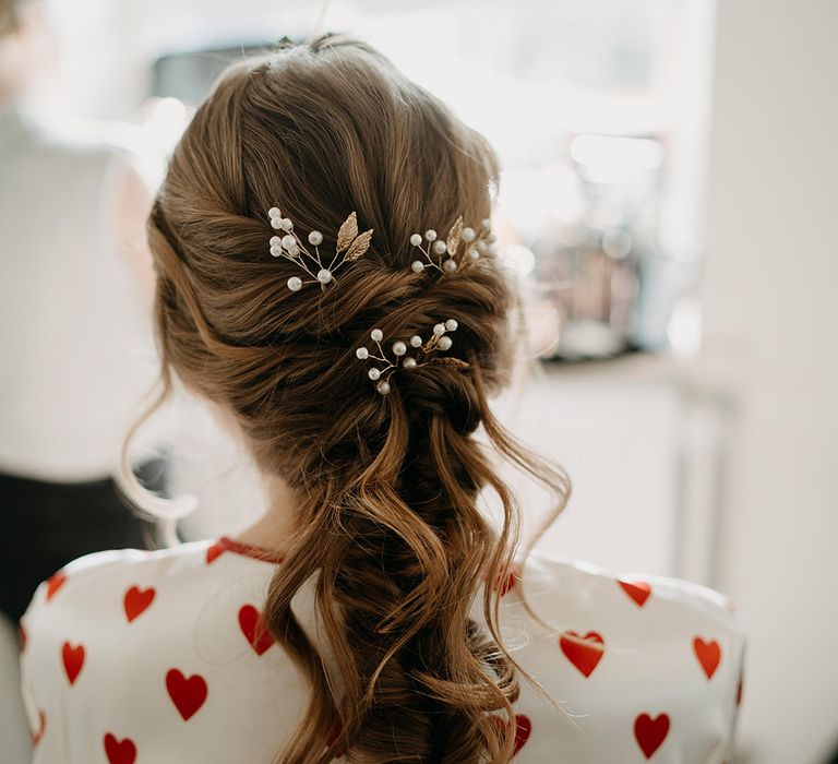 The bride's half up half down wedding hair with delicate gold and pearl hair accessories 