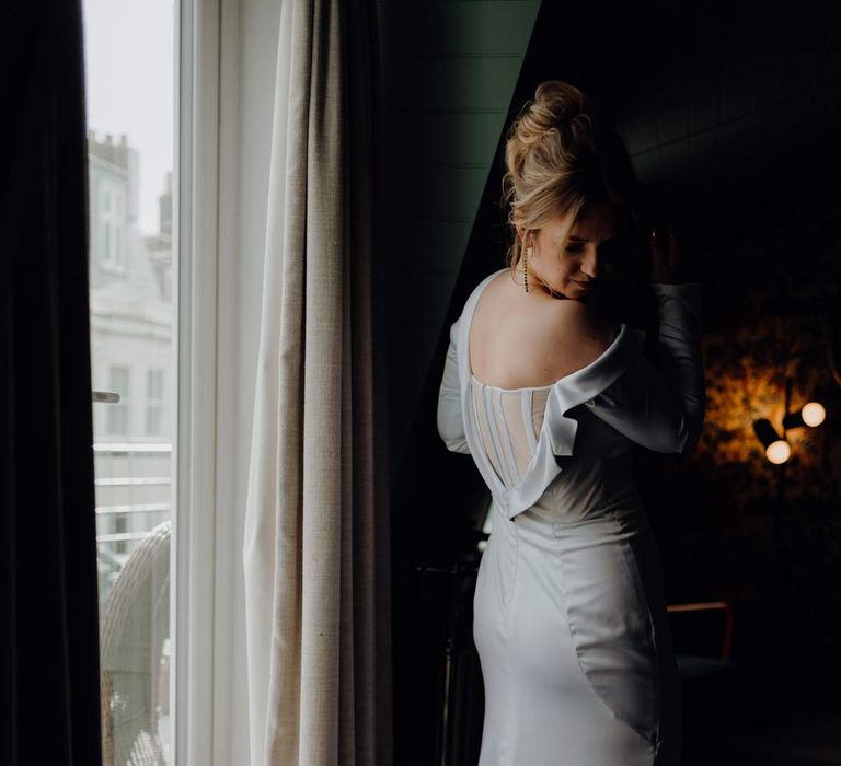 Bride in long sleeve low sheer back satin wedding dress at Fabrica Brighton wedding