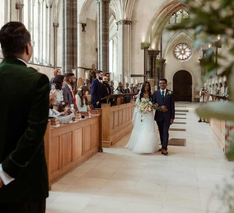 Bride in off the shoulder layered tulle wedding dress walking down the aisle with father of the bride at Inner Temple Hall