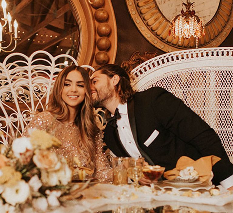 The bride and groom sit together for their wedding breakfast with a non-traditional wedding seating arrangement 