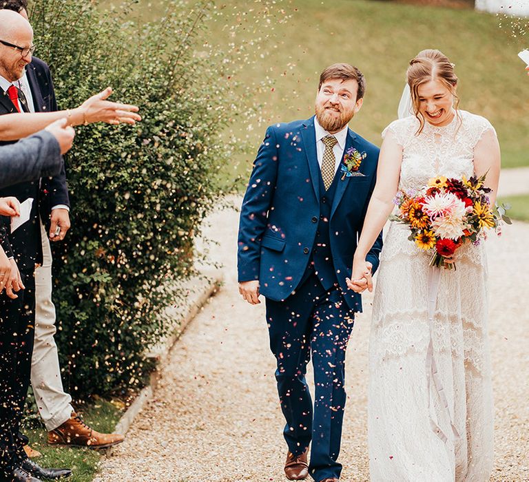 Confetti moment for bride and groom at Coombe Lodge wedding venue 