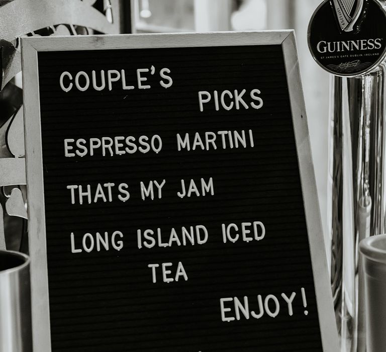 Black and white wedding pegboard with sign for drinks and cocktails 