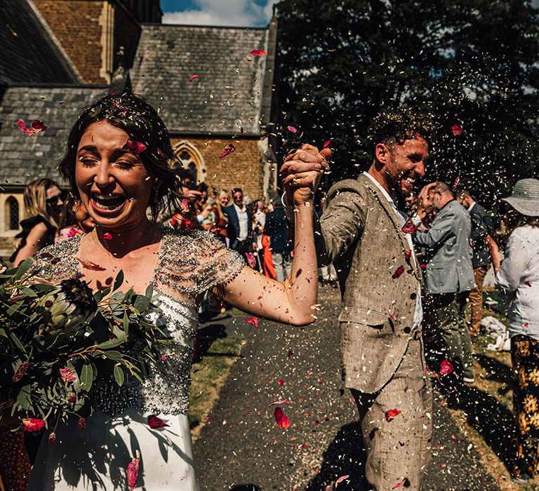 Epic confetti moment with dried petals for bride and groom after their confetti exit 