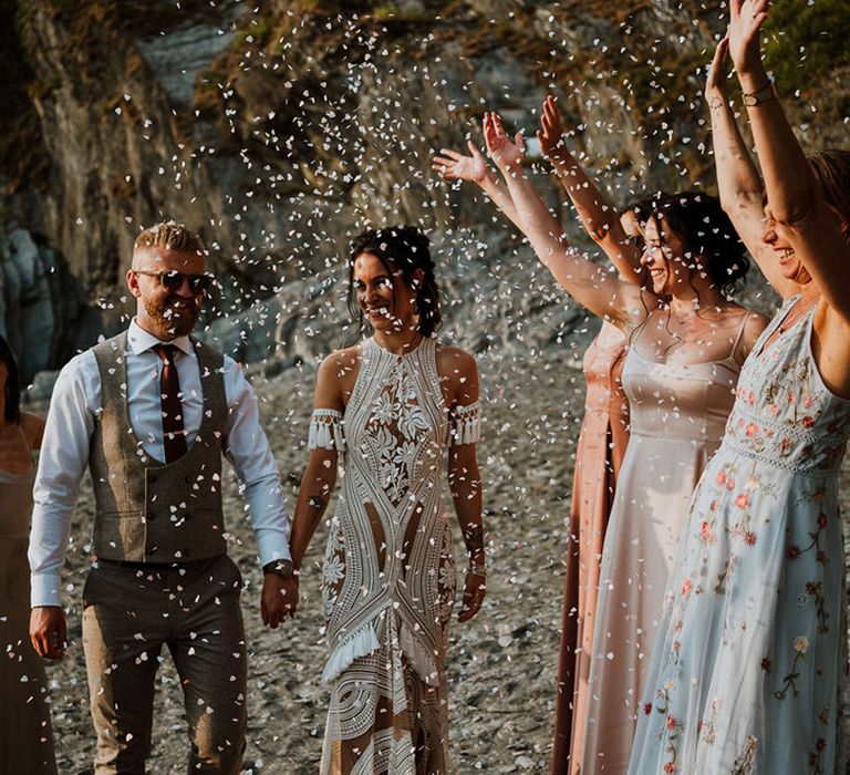 Confetti moment on the beach for coastal wedding at Tunnels Beaches in Devon 