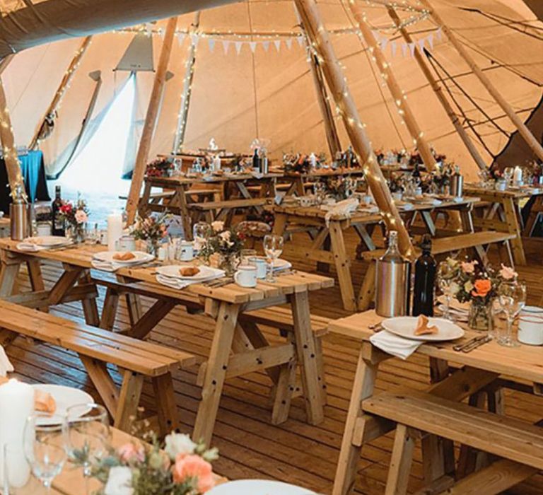 Tipi wedding with fairy lights and colourful flowers for outdoor wedding 