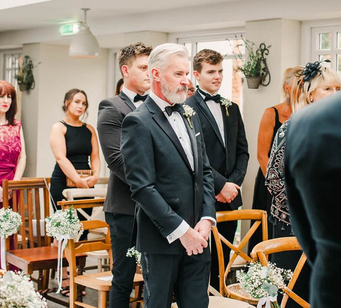 Wedding guests in tuxedos at black tie winter wedding