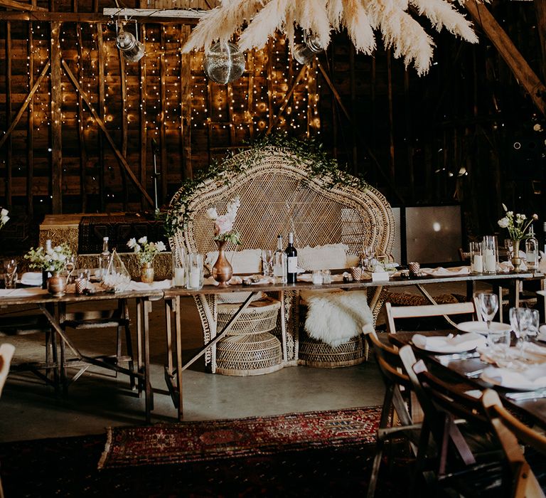 Top table with pampas grass installation and peacock chair love seat