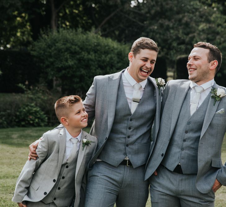 Groomsmen and page boy in grey suits 