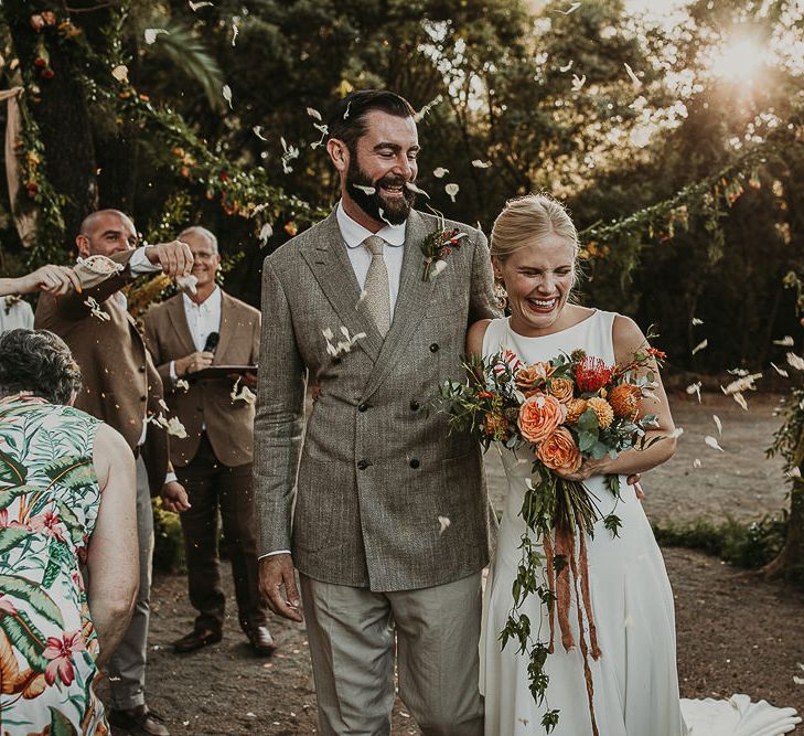 Bride and groom descending up the aisle as husband and wife