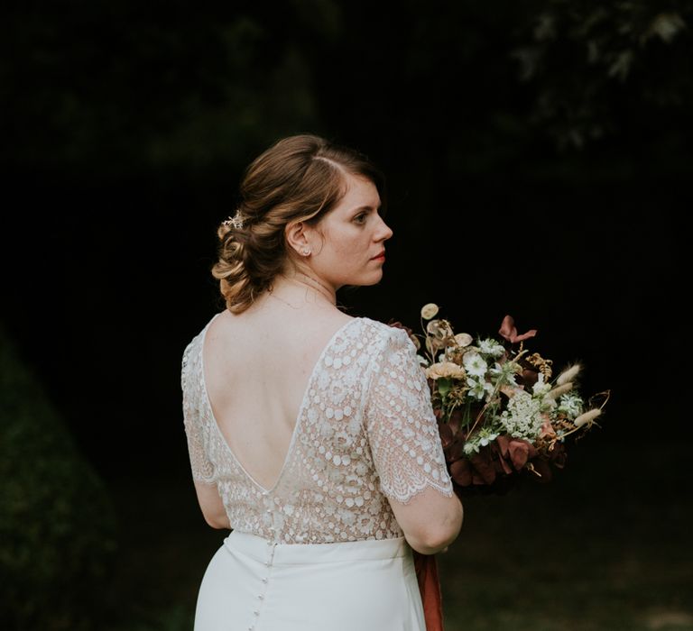 Bride in lace back Laure de Sagazan wedding dress