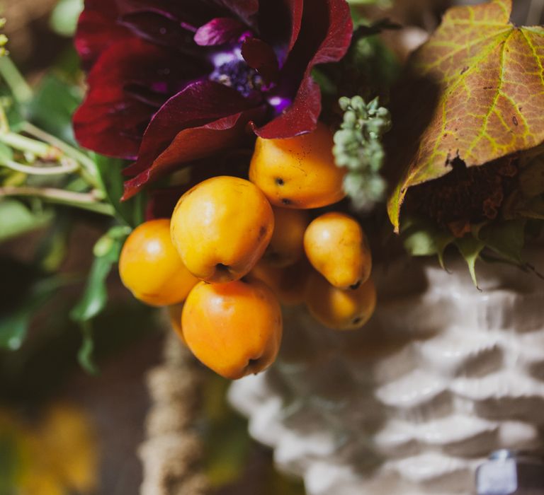 Golden berries as part of earthy wedding ideas floral display