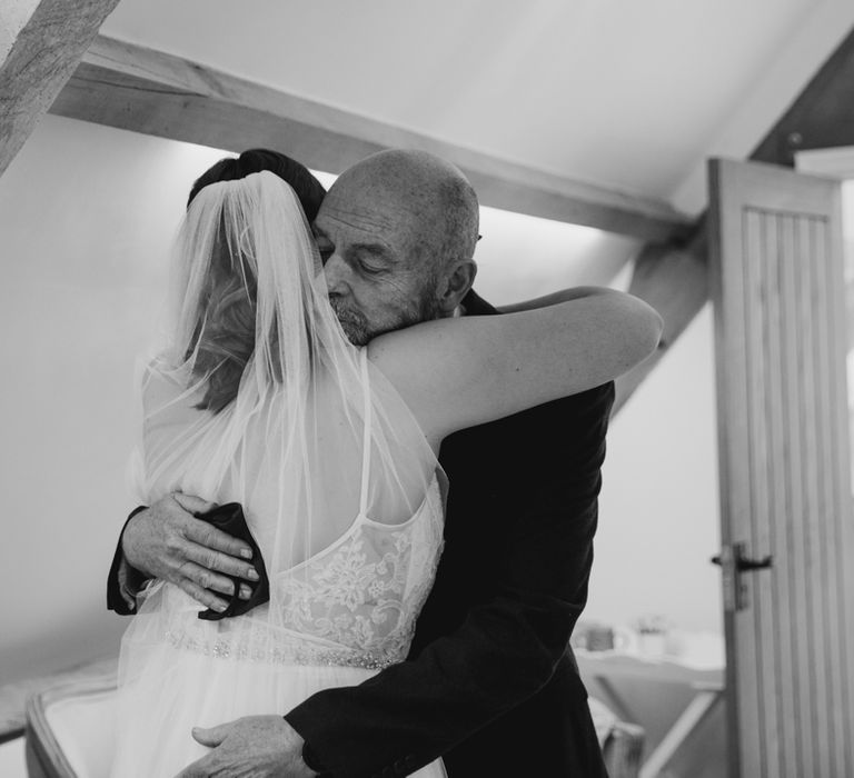 Bride hugging emotional father