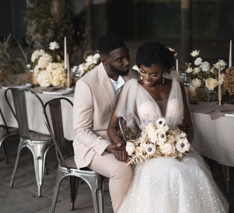 Bride and groom sitting at their wedding breakfast table 