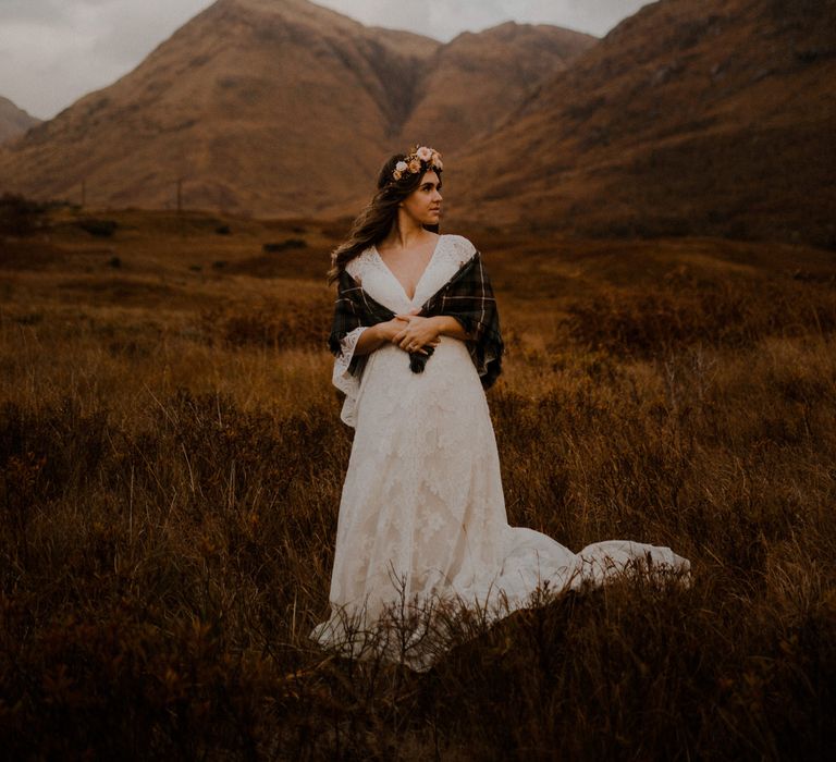 Boho bride with flower crown and tartan shawl at highland wedding in Glencoe