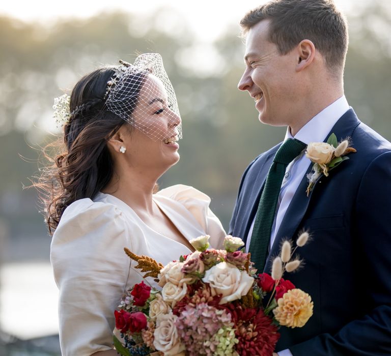 Bride with half up half down hair wearing a birdcage veil 