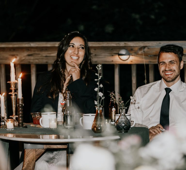 Bride & groom laugh during wedding reception outdoors