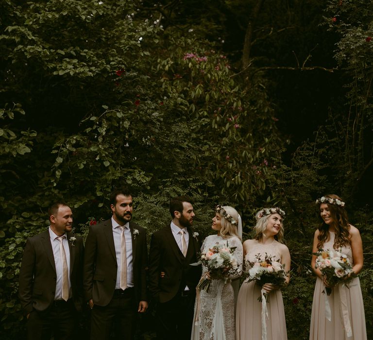 Bride in Grace Loves Lace wedding dress and single tier cathedral length veil stands with groom in black Hugo Boss suit and groomsmen and bridesmaids at Drenagh Estate Wedding