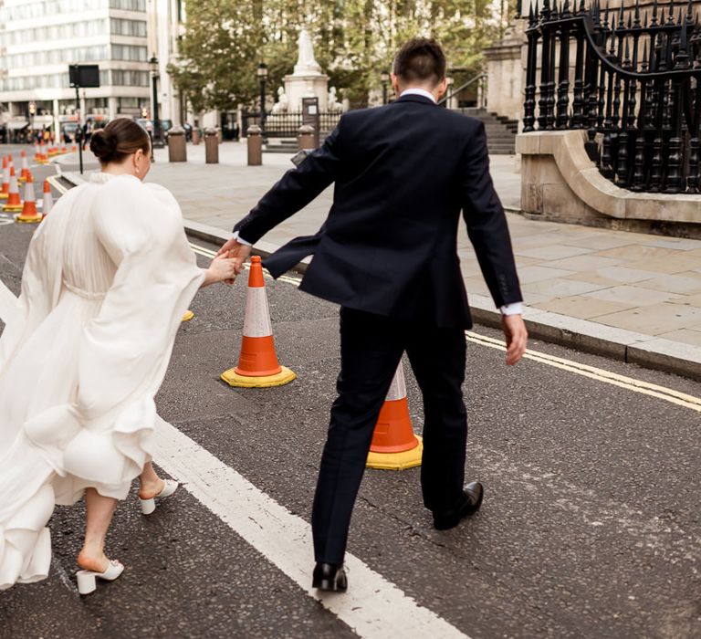 Bride in mules with a billowing ruffle hem bridal cape 