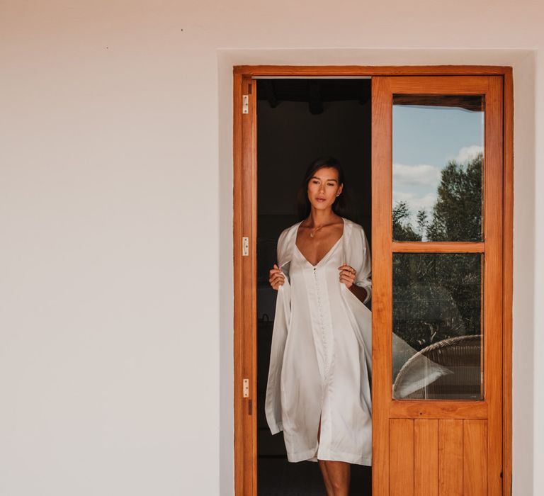 Bride in a satin slip and getting ready robe 